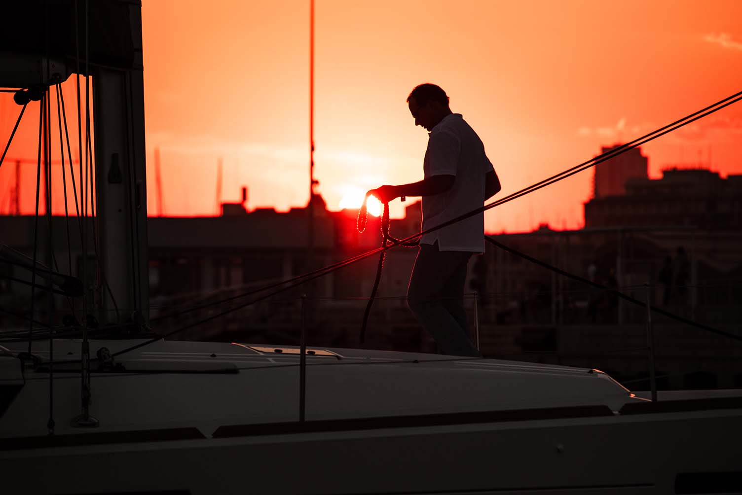 man on boat with rope at sunset 2022 03 04 06 02 21 utc